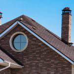 chimney on the roof of the house against the blue sky