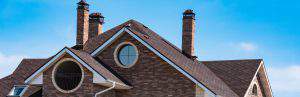 chimney on the roof of the house against the blue sky