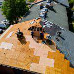Construction worker on a renovation roof the house installed new shingles