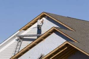 Vinyl siding being installed on a new homw under contruction