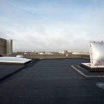Plastic dome on a flat roof on a large building in the heart of the city
