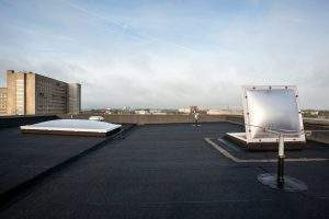 Plastic dome on a flat roof on a large building in the heart of the city