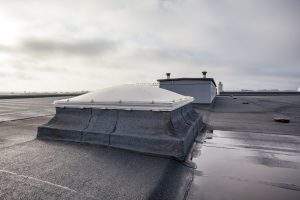 Plastic dome on a flat roof on a large building in the heart of the city