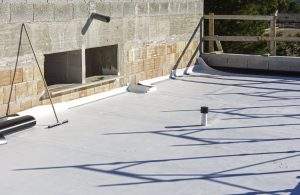 Worker applies pvc membrane roller on roof very carefully. Correct welding with hand-welder, corner.